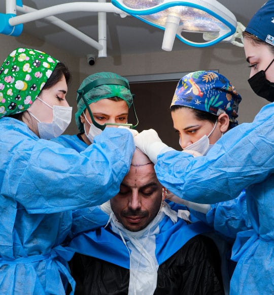 Dr Ciniks and his assitants transplanting hair using FUE technique